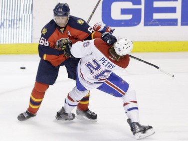 Florida Panthers' Jaromir Jagr of the Czech Republic and Canadiens defenceman Jeff Petry battle for the puck during the second period of an NHL hockey game, Sunday, April 5, 2015, in Sunrise, Fla.