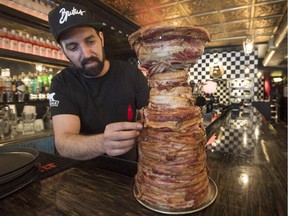 Bar Brutus owner Jean-Francois Leduc touches up his reproduction of the Stanley Cup made with 10 kilograms of bacon, Tuesday, April 14, 2015 in Montreal.