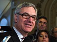 Quebec house leader Jean-Marc Fournier meets media as he arrives at a caucus meeting at the Quebec legislature, Monday, Jan.26, 2015.