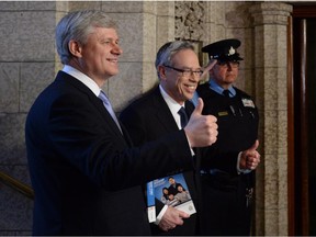 Prime Minister Stephen Harper accompanies Finance Minister Joe Oliver as he makes his way to deliver the federal budget in the House of Commons on Parliament Hill in Ottawa on Tuesday, April 21, 2015.