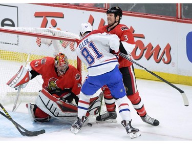 Ottawa Senators goalie Craig Anderson makes a save as Montreal Canadiens forward Lars Eller (81) and Senators defenceman Marc Methot (3) battle for the puck during the second period of game 3 of first round Stanley Cup NHL playoff hockey action in Ottawa on Sunday, April 19, 2015.