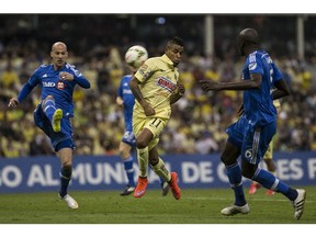 Laurent Ciman of Canada's Montreal Impact, left, competes for the ball with Michael Arroyo of Mexico's America, center, and Hassoun Camara of Canada's Montreal Impact during a CONCACAF Champions league match in Mexico City, Wednesday, April 22, 2015.