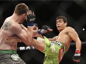 Lyoto Machida, right, from Brazil, fights CB Dollaway, from the United States, during UFB middleweight mixed martial arts bout near Sao Paulo, Brazil, on  Dec. 21, 2014.