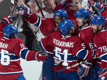 Montreal Canadiens' Max Pacioretty, sedond from right, celebrates his goal past Ottawa Senators goalie Andrew Hammond with teammates P.K. Subban, Devante Smith-Pelly, David Desharnais and Andrei Markov, left to right, during second period of Game 2 NHL Stanley Cup first round playoff hockey action Friday, April 17, 2015 in Montreal.