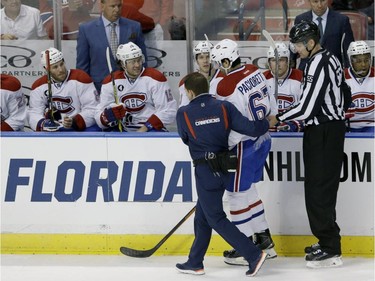 Canadiens' Max Pacioretty is helped off the ice during the first period of an NHL hockey game, Sunday, April 5, 2015, in Sunrise, Fla. Pacioretty left the ice after being interfered with by Florida Panthers defenceman Dmitry Kulikov then falling backward into the boards after his skate made contact with Panthers defenceman Alex Petrovic.