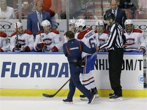 Montreal Canadiens left wing Max Pacioretty (67) is helped off the ice during the first period of an NHL hockey game, Sunday, April 5, 2015 in Sunrise, Fla. Pacioretty left the ice after being interfered with by Florida Panthers defenseman Dmitry Kulikov of Russia, then falling backwards into the boards after his skate made contact with Panthers defenseman Alex Petrovic's. The Canadiens defeated the Panthers 4-1.