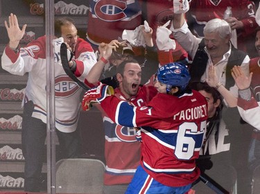 Montreal Canadiens' Max Pacioretty goes up against the glass as he celebrates his goal past Ottawa Senators goalie Andrew Hammond during second period of Game 2 NHL Stanley Cup first round playoff hockey action Friday, April 17, 2015 in Montreal.