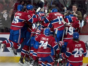 Members of the Montreal Canadiens pile up onto teammate Alex Galchenyuk following his winning goal over the Ottawa Senators during first period overtime of Game 2 NHL Stanley Cup first round playoff hockey action Friday, April 17, 2015 in Montreal. The Canadiens beat the Senators 3-2 to take a 2-0 lead in the best-of-seven series.