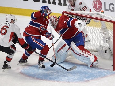 Montreal Canadiens' Andrei Markov scores an own goal on Carey Price as Ottawa Senators' Bobby Ryan (6) and Mika Zibanejad (93) look on during first-period playoff action in Montreal, Wednesday, April 15, 2015.