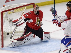 Montreal Canadiens' Brendan Gallagher (11) scores on Ottawa Senators goalie Craig Anderson (41) as Senators' Marc Methot (3) looks on during first period NHL playoff action in Ottawa, Sunday, April 26, 2015.