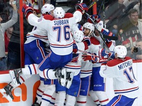 Montreal Canadiens celebrate their 2-1 victory over the Ottawa Senators in sudden death overtime of game 3 of first round Stanley Cup NHL playoff hockey action in Ottawa on Sunday, April 19, 2015.