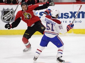 Canadiens' David Desharnais collides with Ottawa Senators' Mark Borowiecki during first period NHL playoff action in Ottawa, Sunday, April 26, 2015.