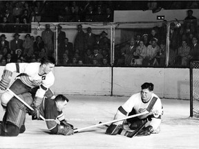 Canadiens defenceman Doug Harvey is bulldogged to the ice by Detroit Red Wings forward Ted Lindsay in front of goaltender Terry Sawchuk during a 1951 game at the Detroit Olympia. The two teams met that season in the playoffs for the fifth time in the 12 times they've now faced each other since 1937.