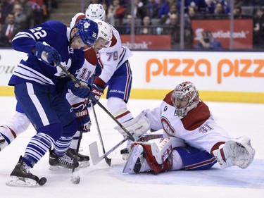 Canadiens goalie Carey Price makes a save on Toronto Maple Leafs' Zach Sill as Brendan Gallagher (11) and Andrei Markov (79) defend during second period NHL action in Toronto on Saturday, April 11, 2015.