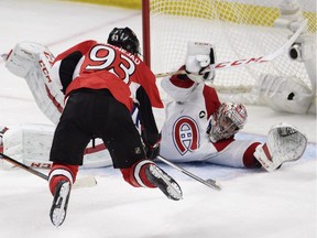 Canadiens goalie Carey Price sprawls to make save on leaping Ottawa Senators player Mika Zibanejad during Game 6 of Eastern Conference quarter-final series in Ottawa on April 26, 2015.