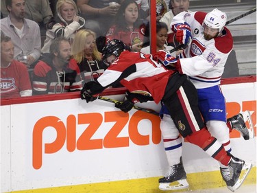 Montreal Canadiens' Greg Pateryn (64) checks Ottawa Senators' Erik Condra (22) into the boards during the first period Stanley Cup NHL playoff hockey action in Ottawa on Wednesday, April 22, 2015.