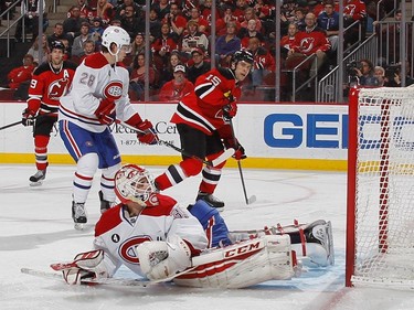 Tuomo Ruutu #15 of the New Jersey Devils looks for a second period rebound from Dustin Tokarski #35 of the Montreal Canadiens  at the Prudential Center on April 3, 2015 in Newark, New Jersey.