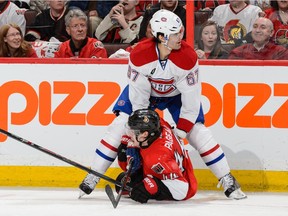 The Canadiens' Max Pacioretty holds down the Senators' Jean-Gabriel Pageau during Game 6 of Eastern Conference quarter-final series in Ottawa on April 26, 2015. The Canadiens eliminated the Senators with a 2-0 victory.