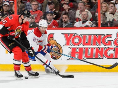 OTTAWA, ON - APRIL 26: Patrick Wiercioch #46 of the Ottawa Senators tries to move the puck past Max Pacioretty #67 of the Montreal Canadiens in Game Six of the Eastern Conference Quarterfinals during the 2015 NHL Stanley Cup Playoffs at Canadian Tire Centre on April 26, 2015 in Ottawa, Ontario, Canada. The Montreal Canadiens eliminated the Ottawa Senators by defeating them 2-0 and move to the next round of the playoffs.