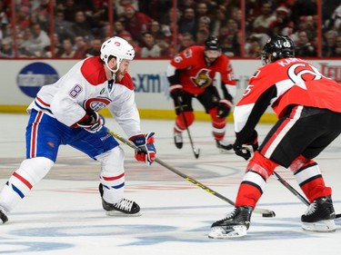 OTTAWA, ON - APRIL 26: Brandon Prust #8 of the Montreal Canadiens tries to move the puck past Erik Karlsson #65 of the Ottawa Senators in Game Six of the Eastern Conference Quarterfinals during the 2015 NHL Stanley Cup Playoffs at Canadian Tire Centre on April 26, 2015 in Ottawa, Ontario, Canada. The Montreal Canadiens eliminated the Ottawa Senators by defeating them 2-0 and move to the next round of the playoffs.