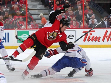 OTTAWA, ON - APRIL 19: Chris Neil of the Ottawa Senators falls to the ice after being checked by Torrey Mitchell #17 of the Montreal Canadiens in Game Three of the Eastern Conference Quarterfinals during the 2015 NHL Stanley Cup Playoffs at Canadian Tire Centre on April 19, 2015 in Ottawa, Ontario, Canada.