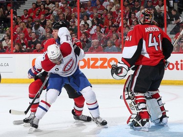 OTTAWA, ON - APRIL 19: Marc Methot #3 of the Ottawa Senators ties up Devante Smith-Pelly #21 of the Montreal Canadiens as Craig Anderson #41 of the Ottawa Senators looks on in Game Three of the Eastern Conference Quarterfinals during the 2015 NHL Stanley Cup Playoffs at Canadian Tire Centre on April 19, 2015 in Ottawa, Ontario, Canada.