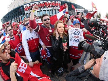 OTTAWA, ON - APRIL 19: Fans surround a CBC TV broadcaster prior to the start of a playoff game between the Ottawa Senators and the Montreal Canadiens during Game Three of the Eastern Conference Quarterfinals during the 2015 NHL Stanley Cup Playoffs at Canadian Tire Centre on April 19, 2015 in Ottawa, Ontario, Canada.