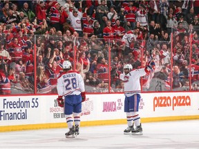 Nathan Beaulieu celebrates his first career NHL goal with teammate P.K. Subban against the Ottawa Senators at the Canadian Tire Centre on February 18, 2015 in Ottawa.