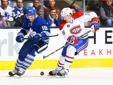 Richard Panik #18 of the Toronto Maple Leafs battles for the puck against Jeff Petry #26 of the Montreal Canadiens during NHL action at the Air Canada Centre April 11, 2015, in Toronto.