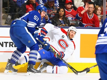 Andrew MacWilliam #57 of the Toronto Maple Leafs knocks down Brandon Prust #8 of the Montreal Canadiens during NHL action at the Air Canada Centre April 11, 2015, in Toronto.