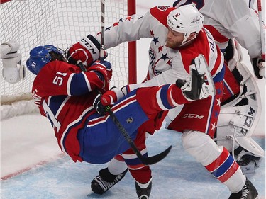 Montreal Canadiens' David Desharnais goes down on hit by Washington Capitals' Tim Gleason, during third period NHL action in Montreal on Thursday April 2, 2015.