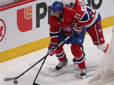 Montreal Canadiens' Devante Smith-Pelly, left, tries to get to puck before Washington Capitals' Michael Latta, during first period NHL action in Montreal on Thursday April 2, 2015.