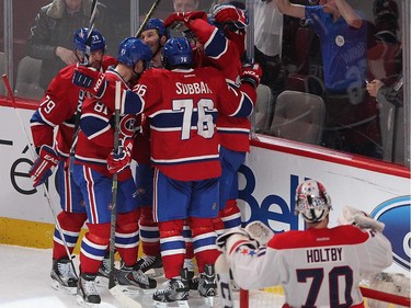 Montreal Canadiens' Lars Eller, back, celebrates his goal with teammates, over Washington Capitals goalie Braden Holtby, during second period NHL action in Montreal on Thursday April 2, 2015.