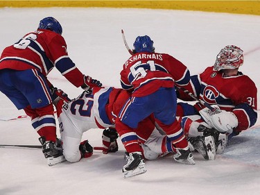 Montreal Canadiens' P.K. Subban pulls away Washington Capitals' Curtis Glencross from Montreal Canadiens goalie Carey Price, with David Desharnais helping out, during third period NHL action in Montreal on Thursday April 2, 2015.