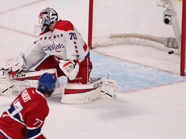 Montreal Canadiens' Tom Gilbert puts the puck past Washington Capitals' Braden Holtby, during second period NHL action in Montreal on Thursday April 2, 2015.