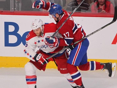 Montreal Canadiens' Torrey Mitchell, right, moves away from hit by Washington Capitals' Tim Gleason, during first period NHL action in Montreal on Thursday April 2, 2015.