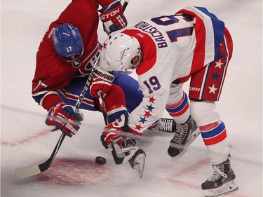 Montreal Canadiens' Torrey Mitchell and Washington Capitals' Nicklas Backstrom, right, battle for puck, during second period NHL action in Montreal on Thursday April 2, 2015.