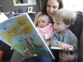 Tara Sadeh, reads Passover book, with her son Weston Mestel, right, and daughter Violet Mestel, at their home on Thursday April 2, 2015. The family is part of a program to distribute Jewish books and thus pass on Jewish values. Each child receives one free Jewish book each month.