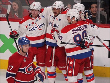 Washington Capitals' Alex Ovechkin, centre, celebrates his goal with teammates while, Montreal Canadiens' Torrey Mitchell skates past, during second period NHL action in Montreal on Thursday April 2, 2015.