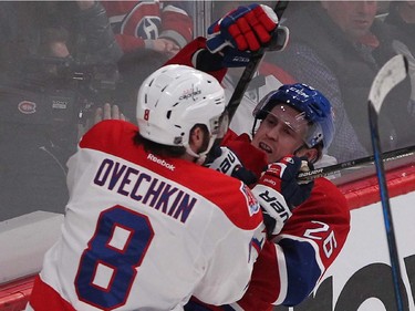 Washington Capitals' Alex Ovechkin and Montreal Canadiens' Jeff Petry, mix it up behind the nets, during second period NHL action in Montreal on Thursday April 2, 2015.