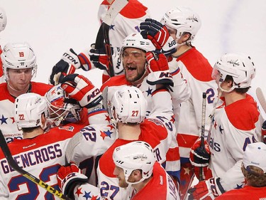Washington Capitals' Alex Ovechkin, centre, celebrates with teammates on their win over the Montreal Canadiens in NHL action in Montreal on Thursday April 2, 2015.