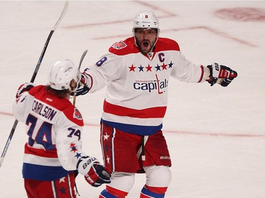 Washington Capitals' Alex Ovechkin celebrates goal with teammate John Carlson, left, the goal by Joel Ward, during third period NHL action in Montreal on Thursday April 2, 2015.