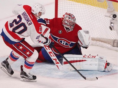 Washington Capitals' Troy Brouwer scores game-winning goal on Montreal Canadiens goalie Carey Price, during shootout NHL action in Montreal on Thursday April 2, 2015.
