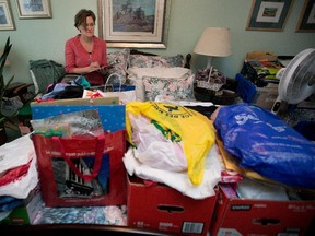 Personal organizer Kathleen Murphy works on clearing some clutter for a client in Montreal. “There’s only so much a house, a closet, a drawer will take," she says.