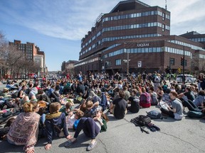 Protesters supporting the student strike at the Cégep du Vieux Montréal stage a short sit-in outside a UQAM building on the corner of Berri street and de Maisonneuve boulevard in Montreal on Monday, April 13, 2015.