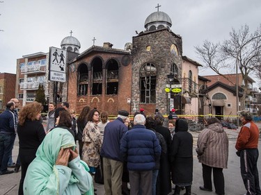 A parishioner cries as people gather at the scene of the overnight fire at the Koimisis Tis Theotokou Greek Orthodox Church, also called Panagitsa, in Parc Extension in Montreal April 14, 2015.