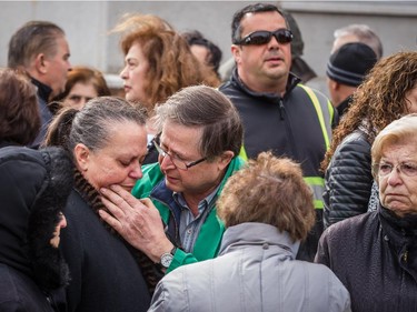 A woman is comforted  at the scene of the overnight fire at the Koimisis Tis Theotokou Greek Orthodox Church, also called Panagitsa,in Parc-Extension April 14, 2015.