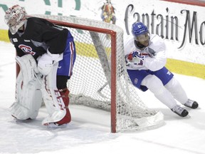 The Canadiens' Devante Smith-Pelly cuts close past Carey Price's net during practice at the Bell Sports Complex in Brossard on April 14, 2015.