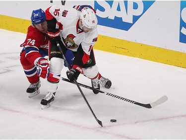 Montreal Canadiens' Alexei Emelin and Ottawa Senators' Clarke MacArthur battle for puck during first-period action in Montreal on Wednesday April 15, 2015.