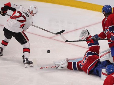 APRIL  15, 2015 -- Montreal Canadiens goalie Carey Price dives toward puck on play by Ottawa Senators' Curtis Lazar during third- period action in Montreal on Wednesday, April 15, 2015.